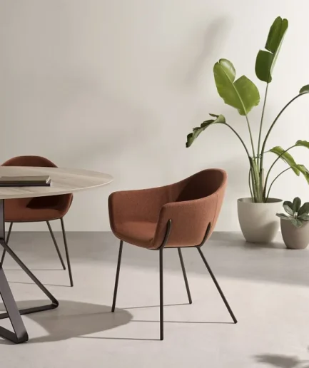 Silla de comedor Viva de Pemi con estructura metálica lacada y asiento tapizado con brazos, diseño moderno y confortable.