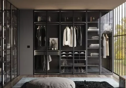 Vestidor Nolimits Next con puertas de cristal transparente, iluminación LED integrada y acabado oscuro Vulcano con interiores personalizables y accesorios de almacenaje.