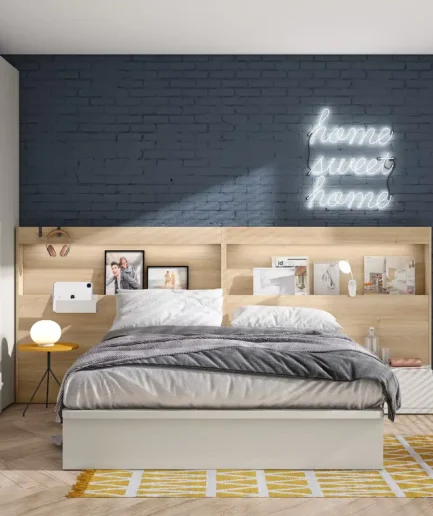 Dormitorio moderno con cabecero BOX en acabado Lino, equipado con un hueco superior para decoración y opción de iluminación LED. La estancia incluye una mesita redonda en color Ámbar, cama y armario en acabado Gris Perla, creando un ambiente contemporáneo, funcional y personalizado.